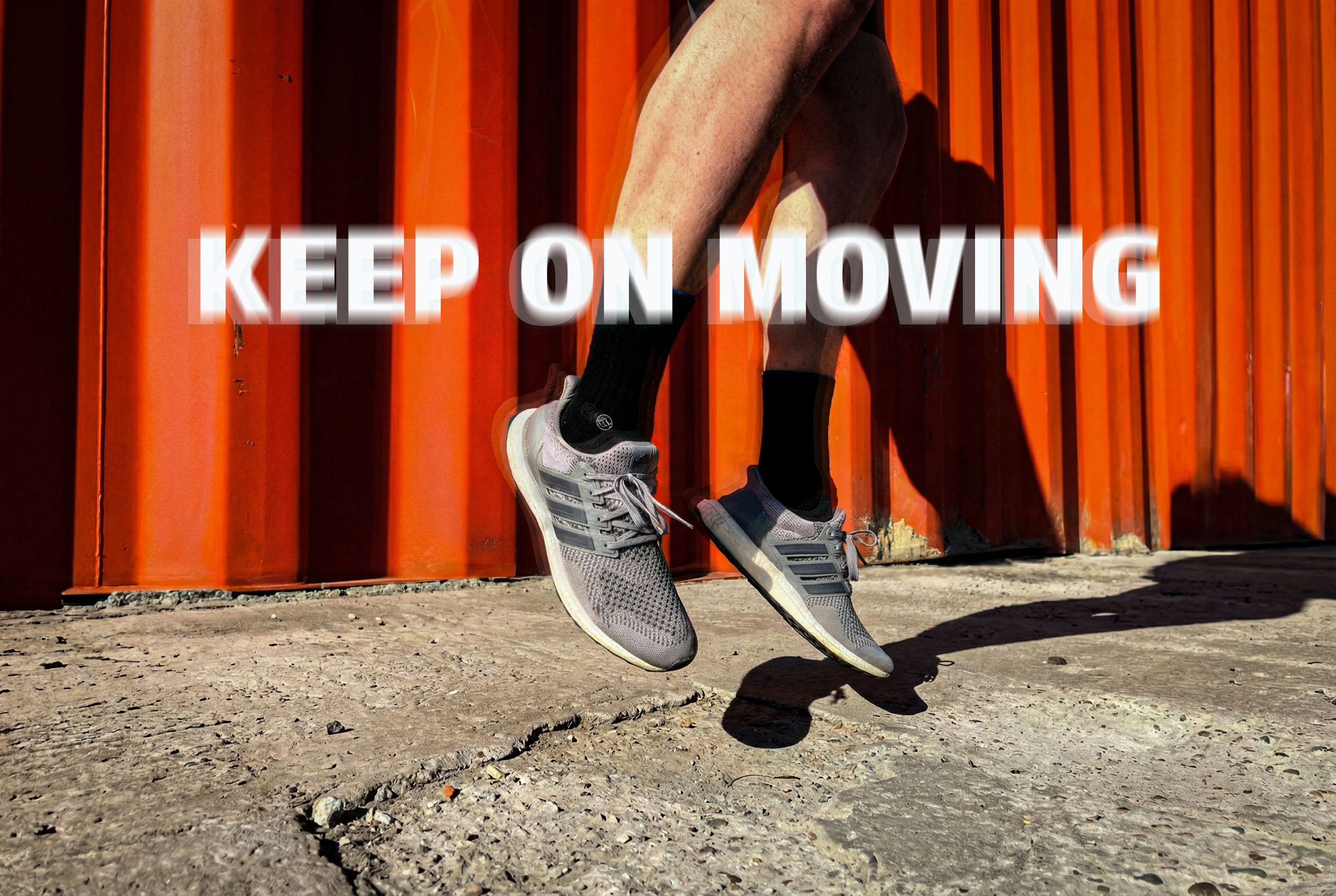 Black WALK IT OFF merino wool socks while jumping in sneakers.