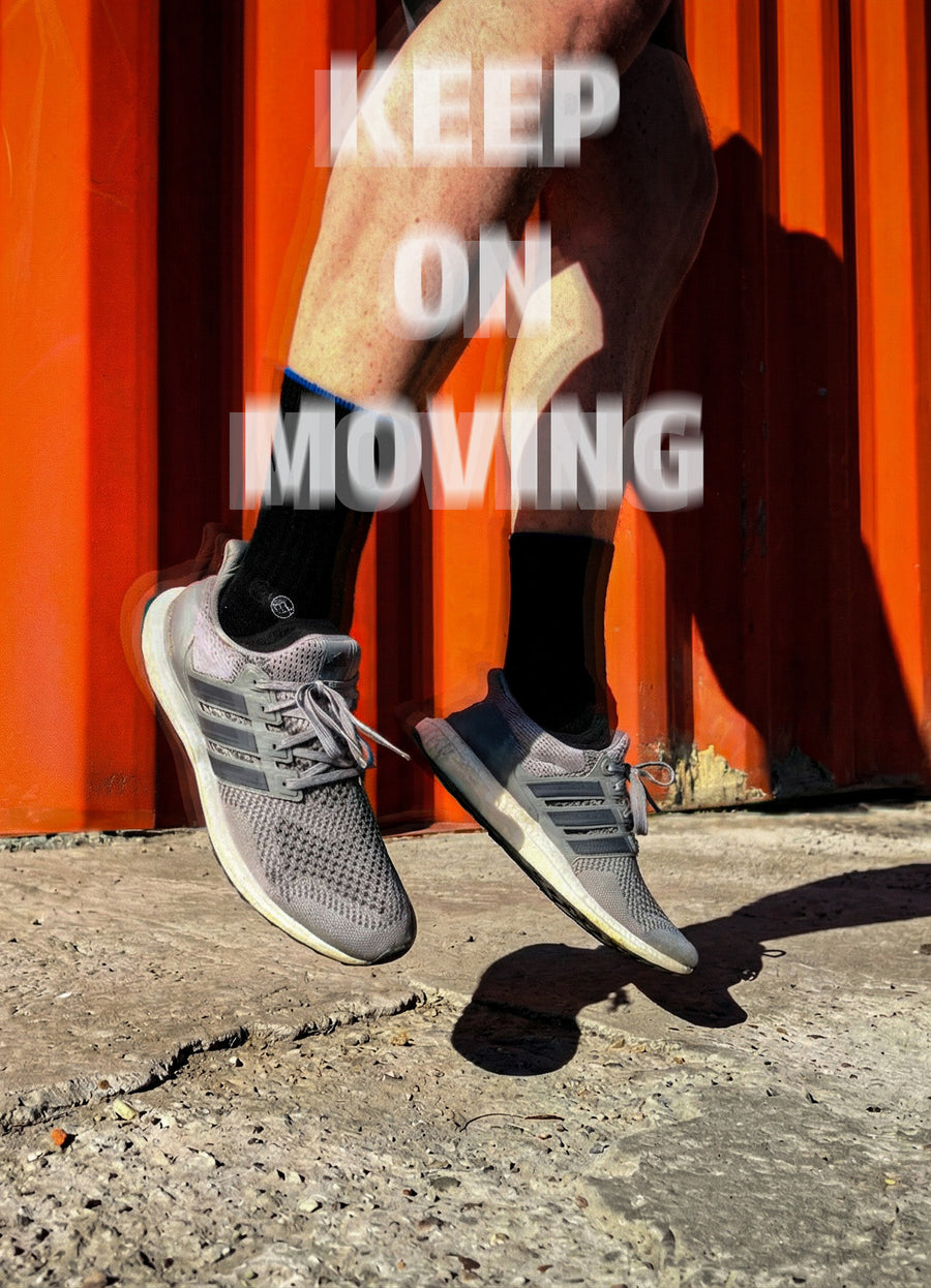 Black WALK IT OFF merino wool socks while jumping in sneakers.