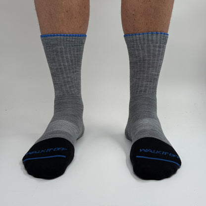 Model draagt de WALK IT OFF merino sokken in de kleur Twister, gefotografeerd recht van voren op een witte achtergrond.